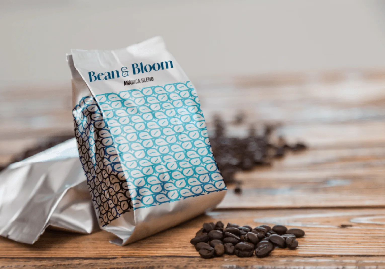 Silver coffee bag with a blue bean and leaf pattern